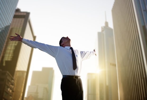 Image of a man with arms open celebrating - represents a schoolteacher celebrating after making a million dollars