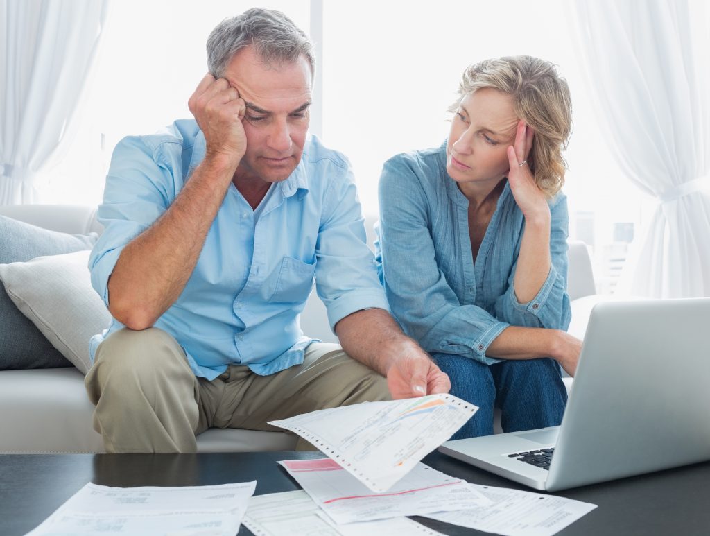 Image of a couple worried about their bills - Shows that budgeting is not the way to say Goodbye to Money Stress